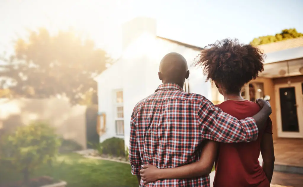 Couple looking at a home they plan to buy in warm afternoon light